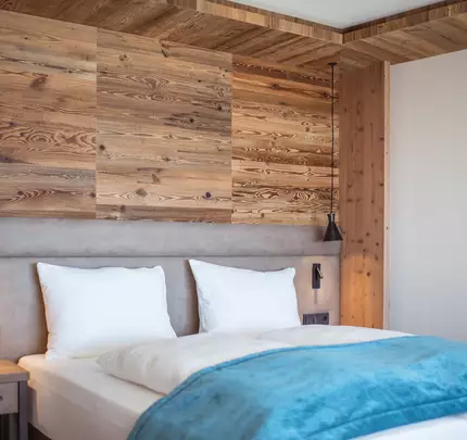 Double bed with wood paneling