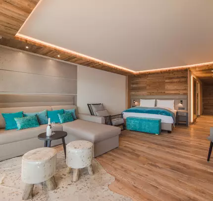 View of sofa with table, double bed, and rocking chair